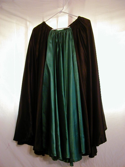 Green and Black Satin Circle Skirt. Made of ten yards of boroque satin. Has a nice weight for spins. Thirty-six inches, hip to ankle, fits a variety of hip sizes S - M.
Cost \\$90.00 plus shipping.
